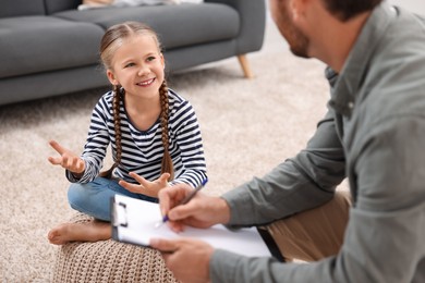 Dyslexia treatment. Therapist working with girl in room