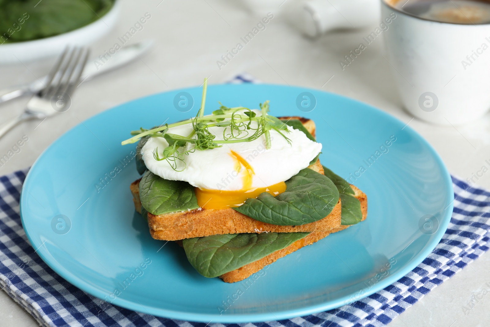 Photo of Delicious poached egg sandwich served on blue plate