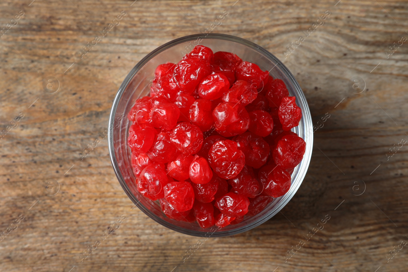 Photo of Bowl of sweet cherries on wooden background, top view. Dried fruit as healthy snack