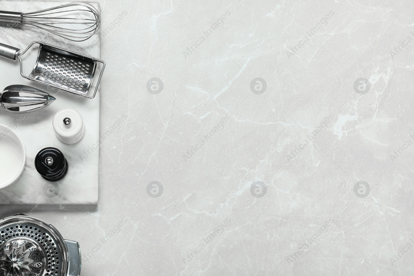 Photo of Set of different kitchen utensils on grey marble table, flat lay. Space for text