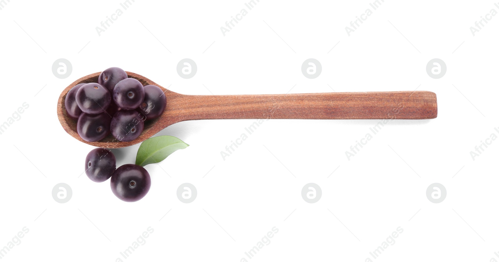 Photo of Fresh acai berries and wooden spoon isolated on white, top view