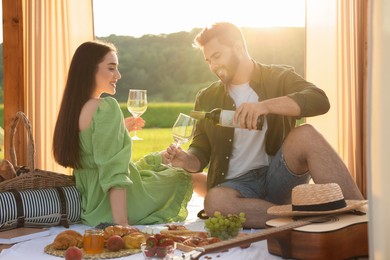 Romantic date. Beautiful couple having picnic outdoors on sunny day