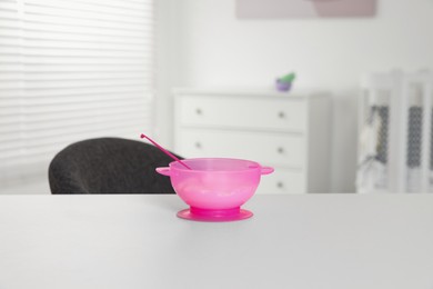 Photo of Plastic bowl with tasty yogurt on white table indoors