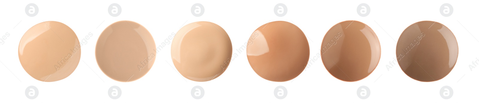 Image of Set with different shades of liquid skin foundation on white background, top view. Banner design