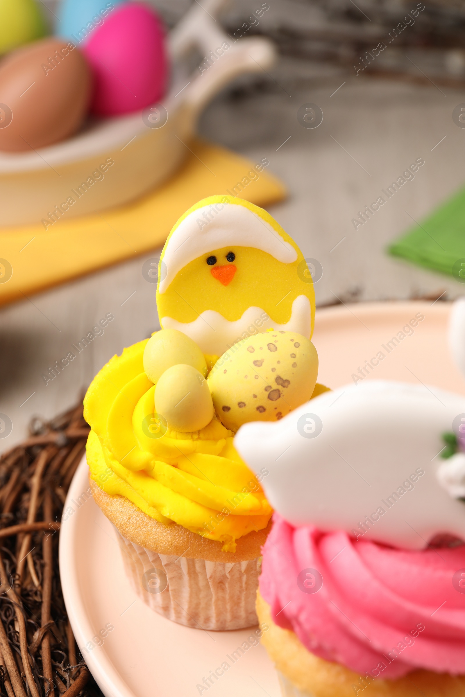 Photo of Tasty decorated Easter cupcakes on table, closeup