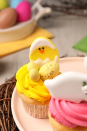 Photo of Tasty decorated Easter cupcakes on table, closeup