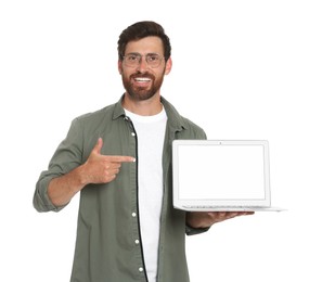 Photo of Handsome man pointing at laptop on white background