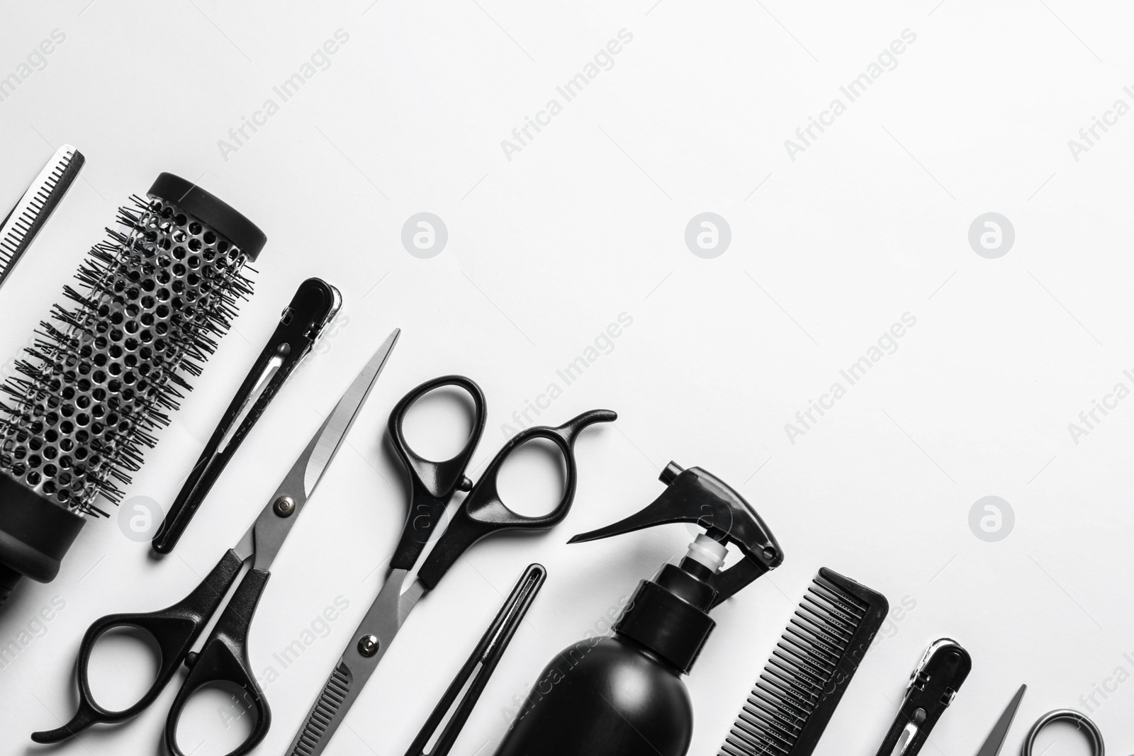 Photo of Composition with scissors and other hairdresser's accessories on white background, top view