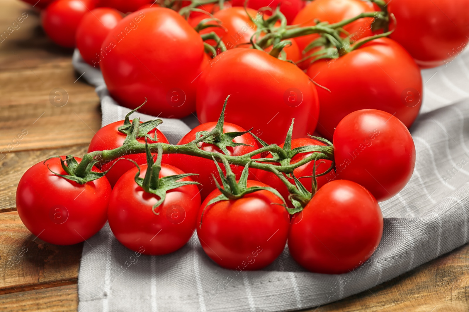 Photo of Fresh ripe red tomatoes on wooden table