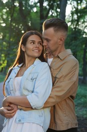 Photo of Happy young couple having good time together in park