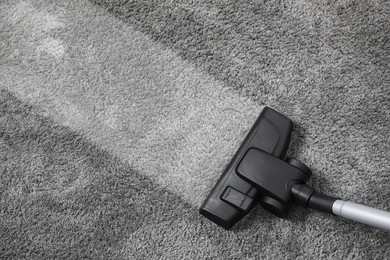 Vacuuming carpet. Clean area after using device, top view