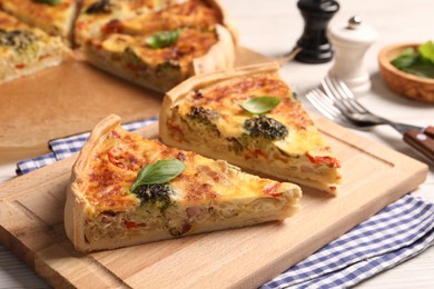 Photo of Delicious homemade vegetable quiche on wooden board