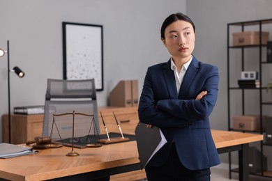 Portrait of notary with crossed arms in office. Space for text