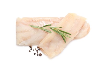 Photo of Pieces of raw cod fish, rosemary and peppercorns isolated on white, top view