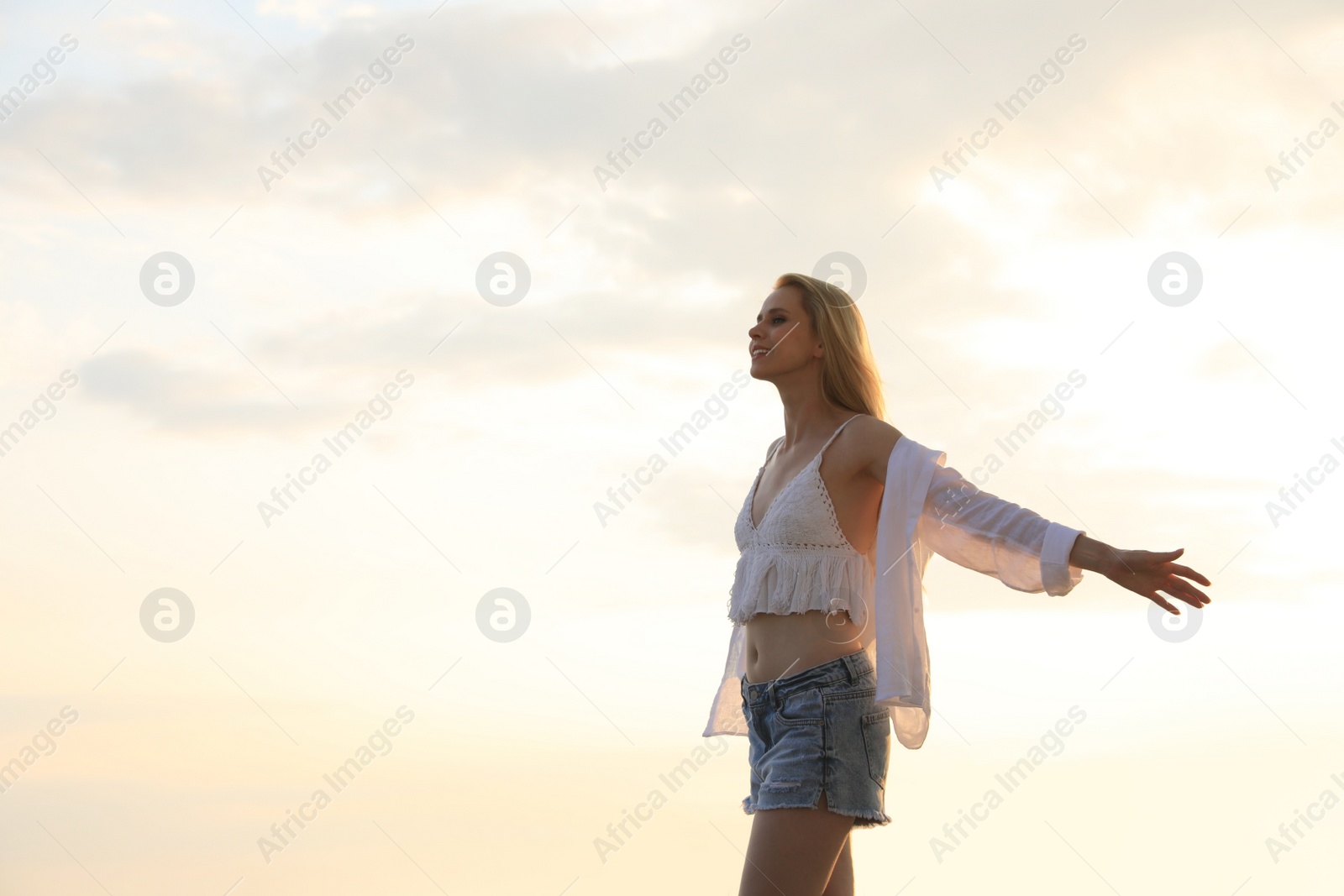 Photo of Beautiful young woman outdoors on sunny day, space for text