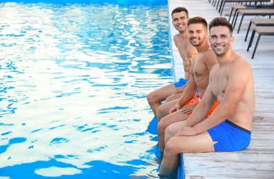 Group of friends near outdoor swimming pool