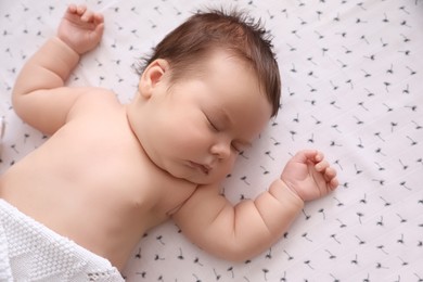 Photo of Cute little baby sleeping in crib at home, top view. Bedtime