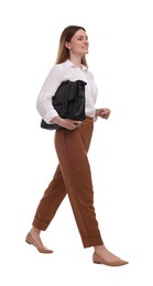 Beautiful businesswoman with briefcase walking on white background