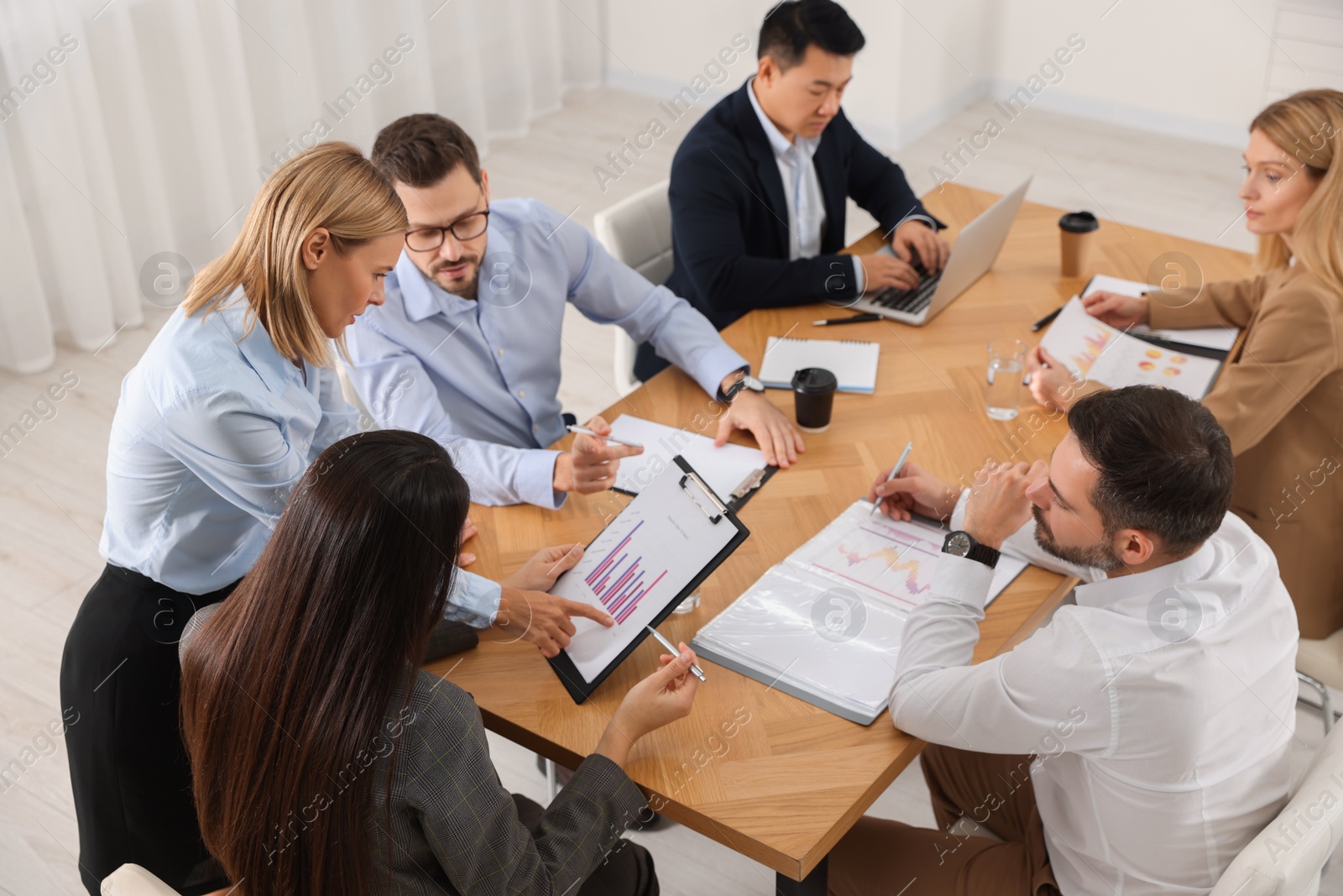 Photo of Businesswoman showing chart on meeting in office