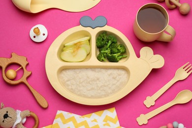 Photo of Toys, pacifier and plastic dishware with healthy baby food on pink background, flat lay