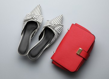 Stylish woman's bag and shoes on light background, flat lay