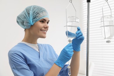 Photo of Nurse setting up IV drip in hospital