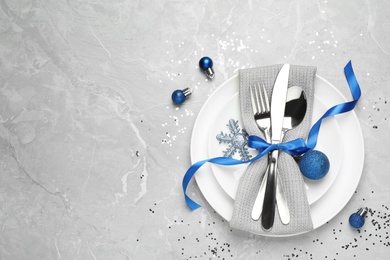 Beautiful Christmas table setting on grey background, flat lay. Space for text