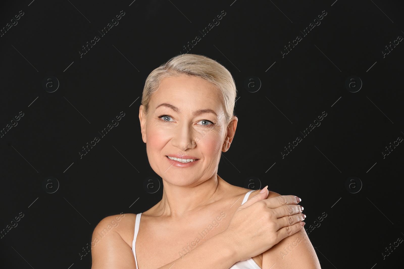 Photo of Portrait of beautiful mature woman on black background