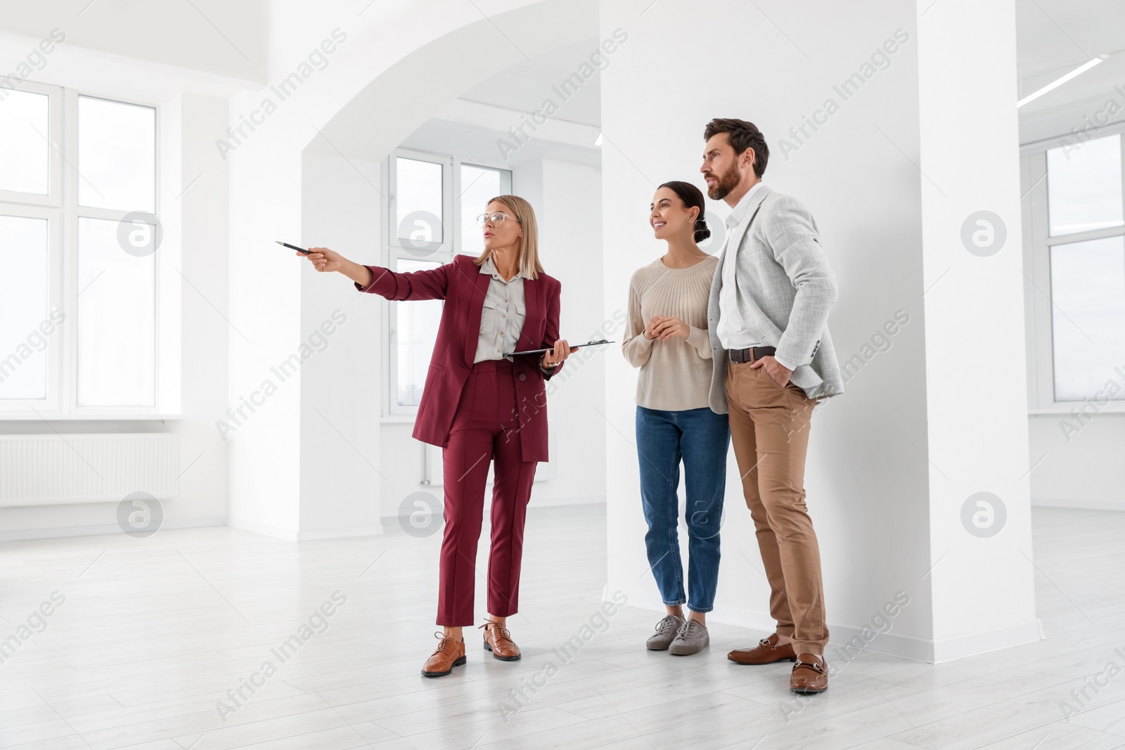 Photo of Real estate agent showing new apartment to couple