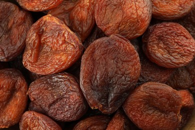 Photo of Tasty dried apricots as background, top view