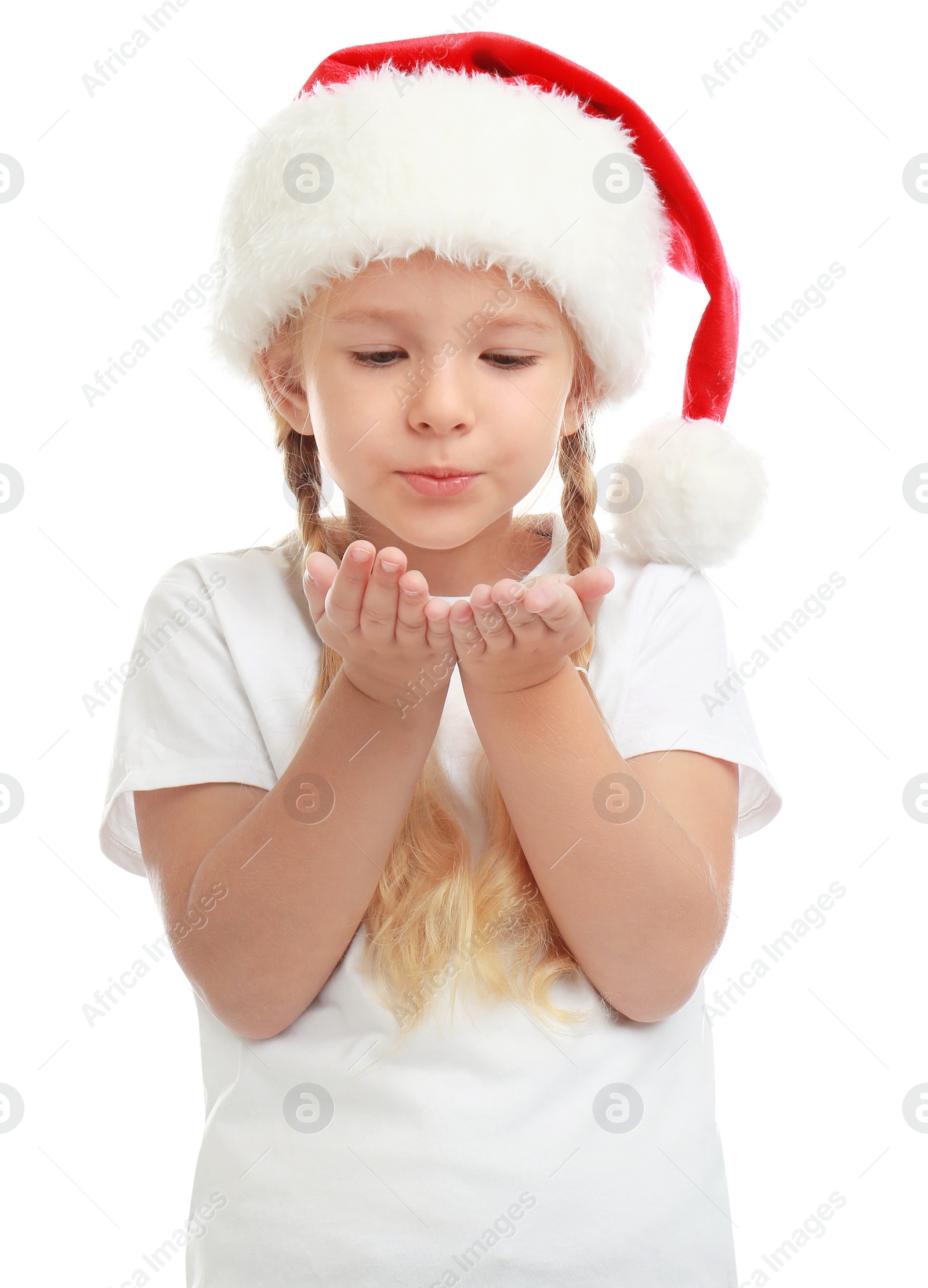 Photo of Cute little child wearing Santa hat on white background. Christmas holiday