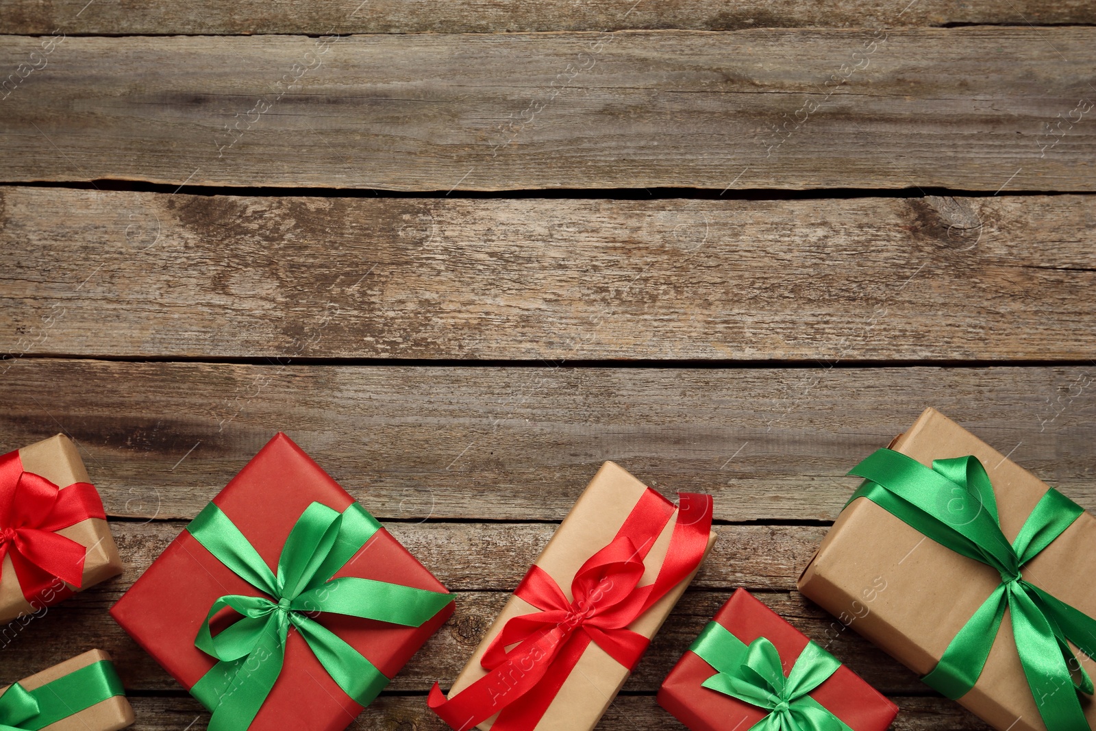 Photo of Many gift boxes on wooden table, flat lay. Space for text