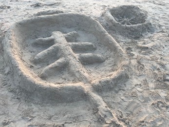 Photo of Palm tree made of sand on beach