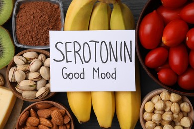 Photo of Many different products and card with phrase Serotonin Good Mood on table, flat lay. Natural antidepressants
