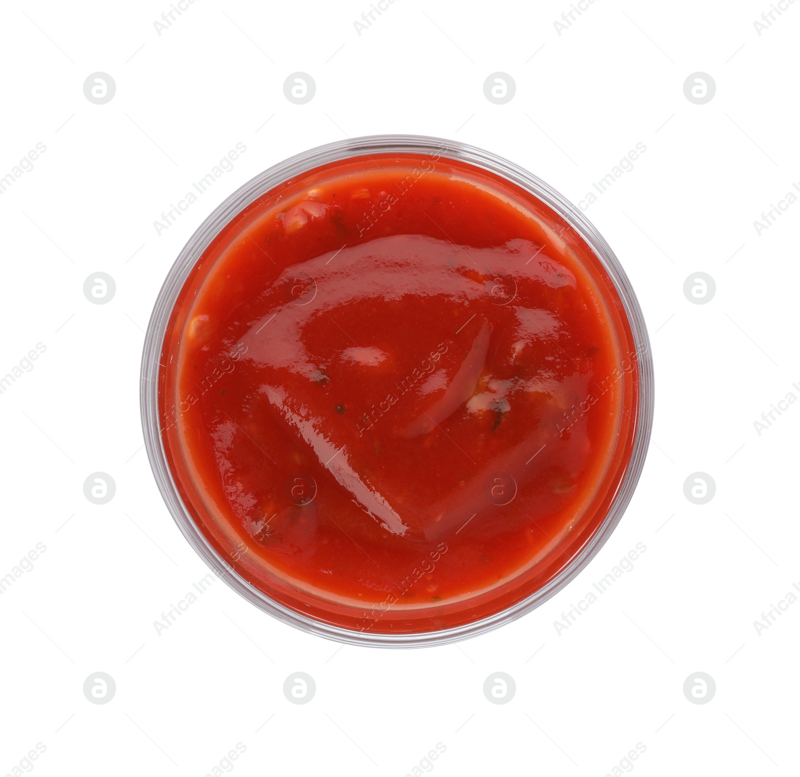 Photo of Glass of spicy chili sauce on white background, top view