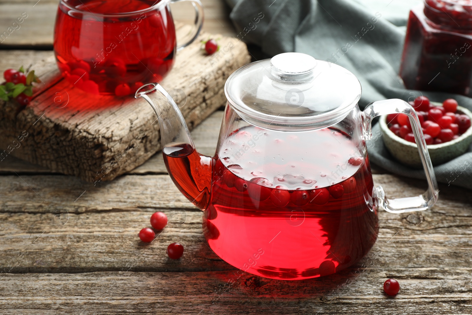 Photo of Delicious cranberry tea and berries on wooden table