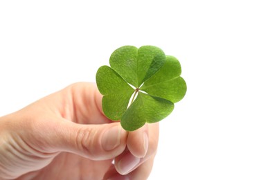 Woman holding beautiful green four leaf clover on white background, closeup