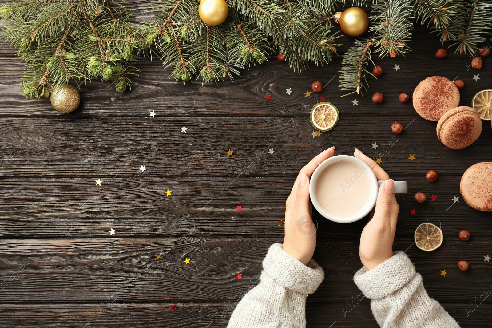 Photo of Woman with delicious hot cocoa drink at table, top view