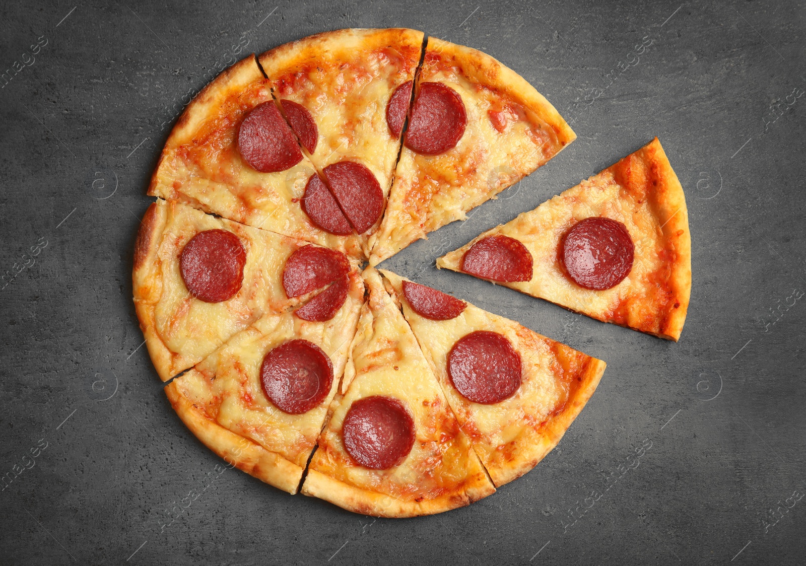 Photo of Tasty pepperoni pizza on grey table, flat lay