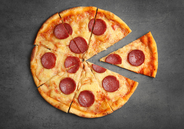 Photo of Tasty pepperoni pizza on grey table, flat lay