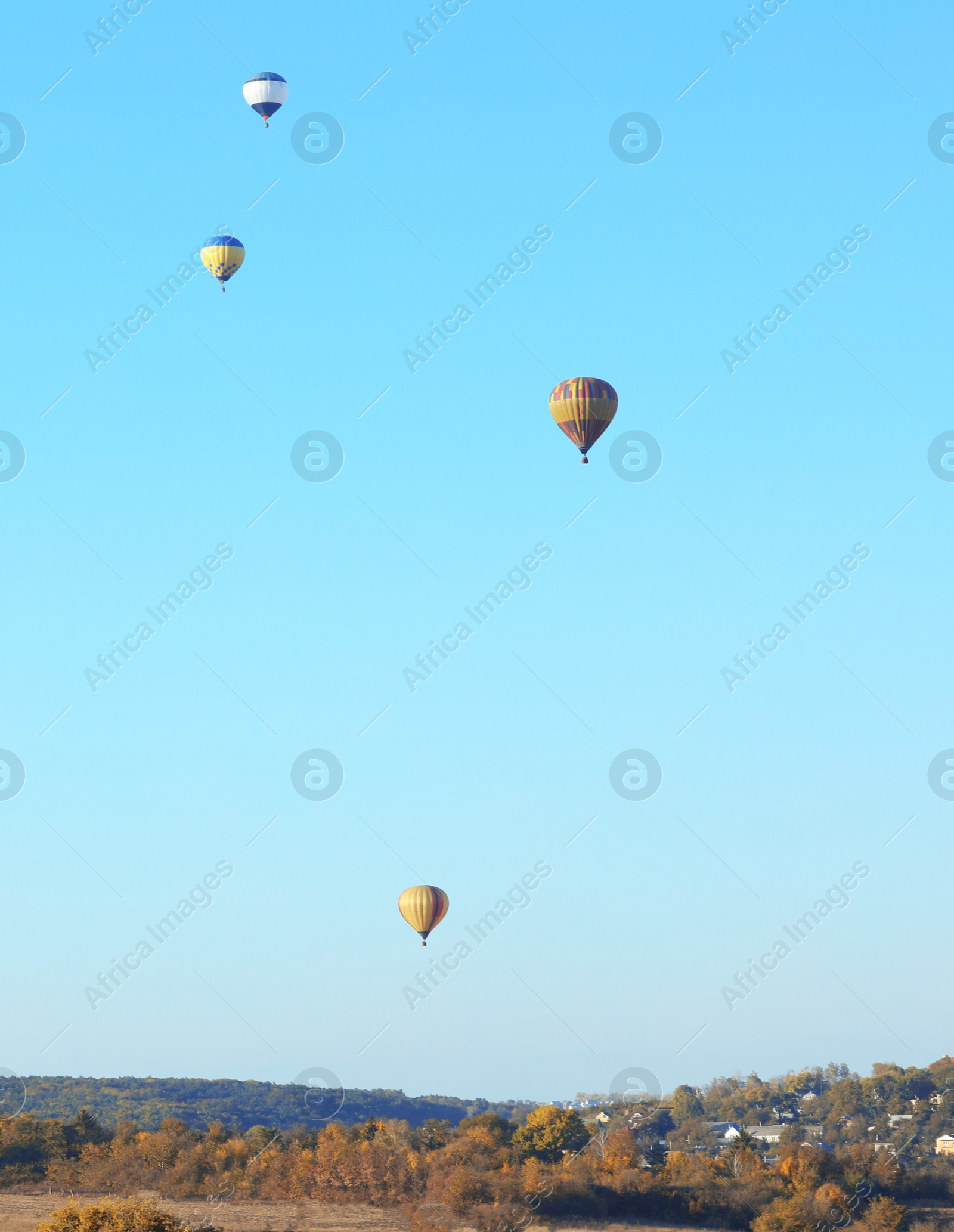 Photo of Colorful hot air balloons flying over countryside