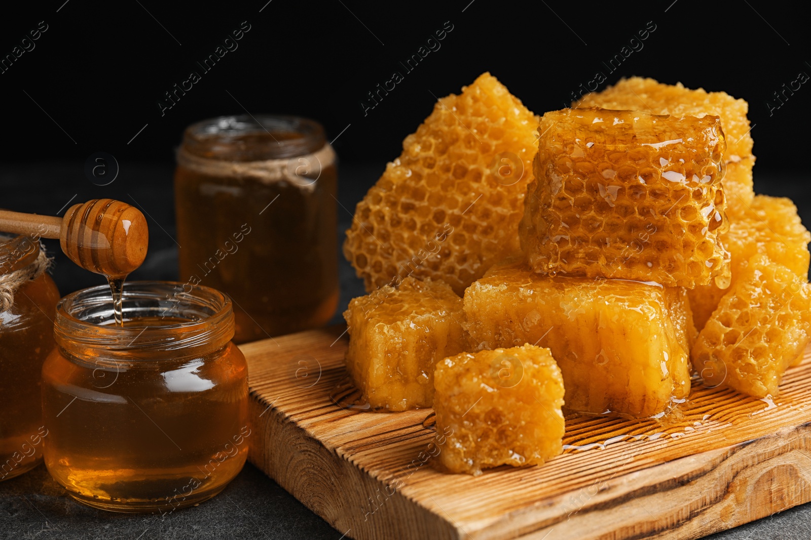 Photo of Composition with fresh honey on grey table