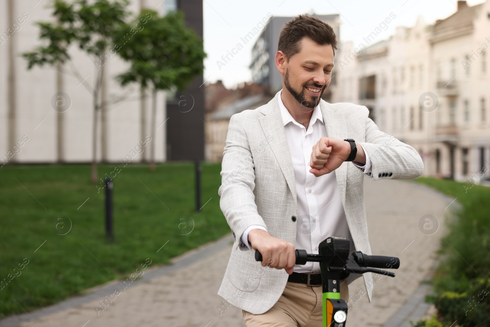 Photo of Businessman with modern kick scooter on city street, space for text