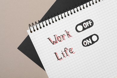 Photo of Words Life and Work near drawn switchers in notebook on beige background, top view. Balance concept