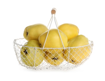 Photo of Fresh ripe quinces in basket on white background