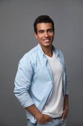 Photo of Handsome young African-American man on grey background