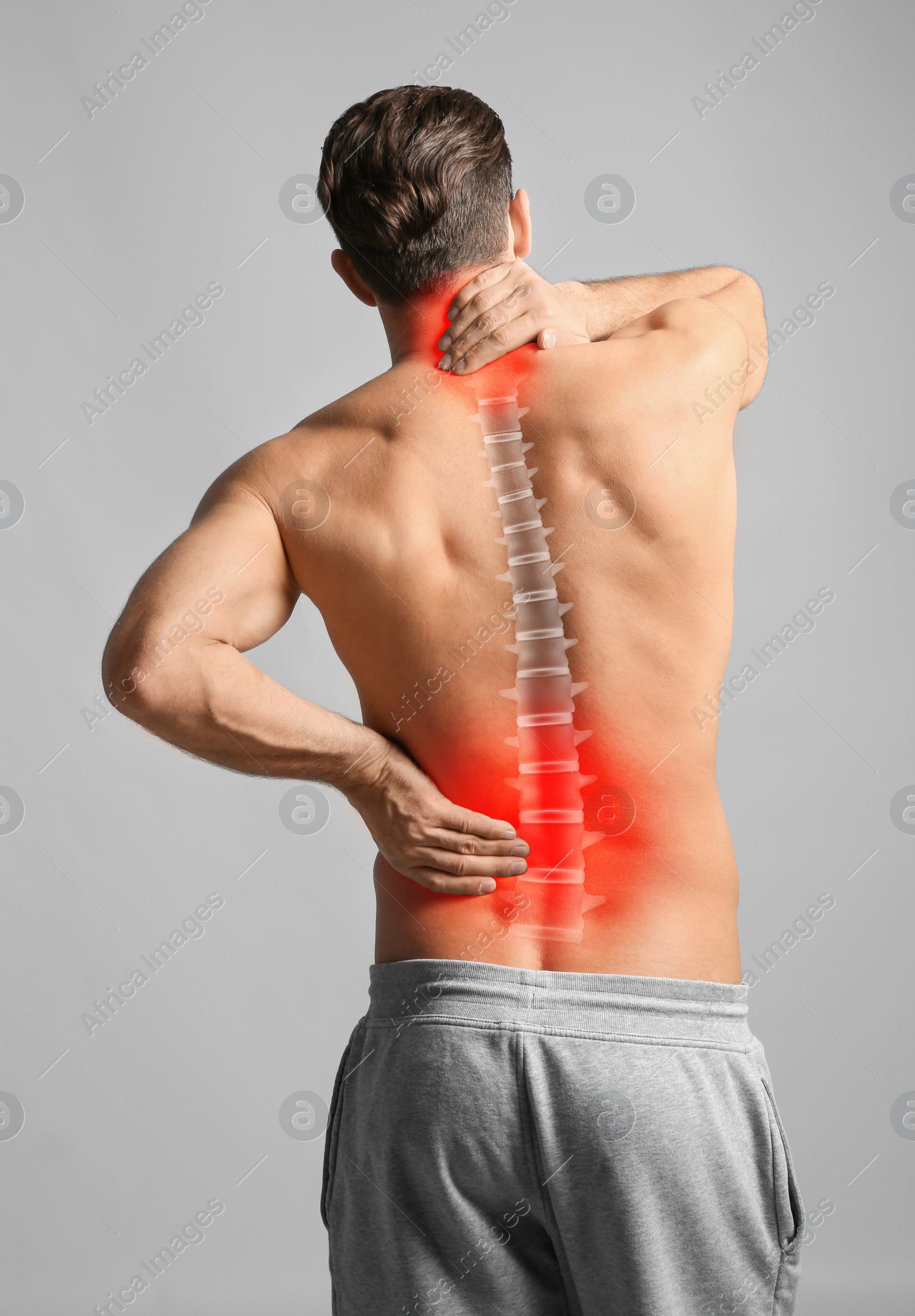 Image of Man suffering from back and neck pain on light grey background