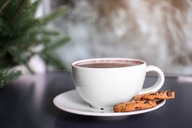 Photo of Cup of aromatic cacao with cookies on table, closeup. Space for text