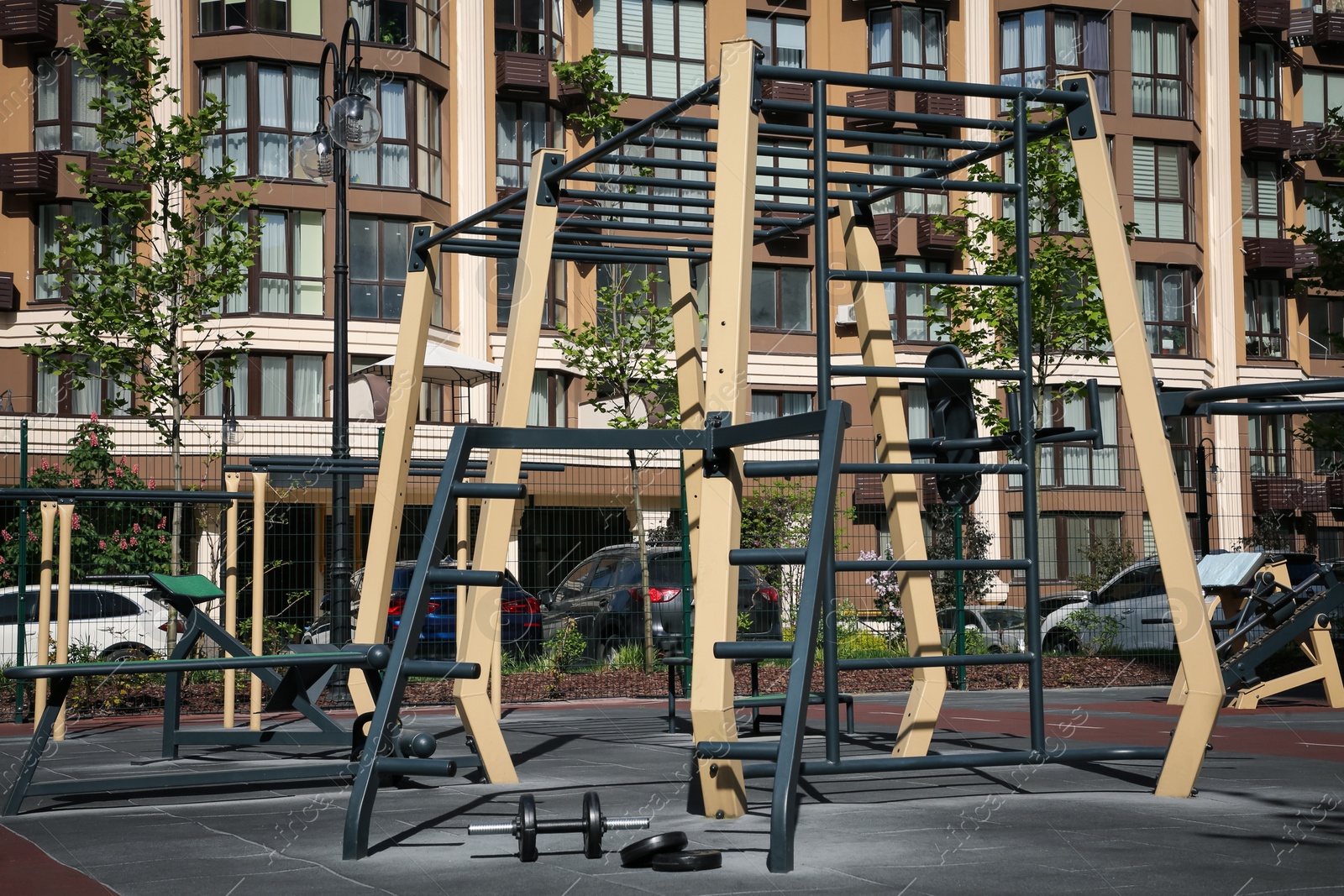 Photo of Empty outdoor gym with different sport simulators in residential area