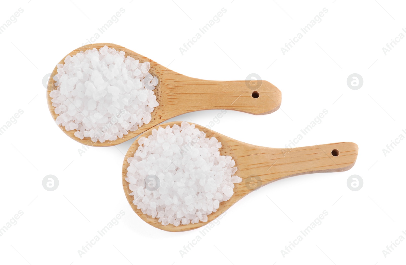 Photo of Wooden spoons with natural sea salt isolated on white, top view